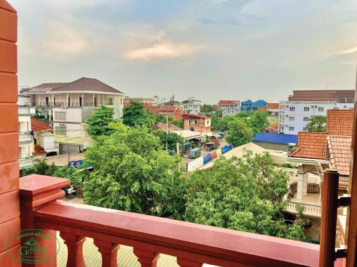 a balcony with a view of a city at Garden Village Guesthouse & Pool Bar in Siem Reap