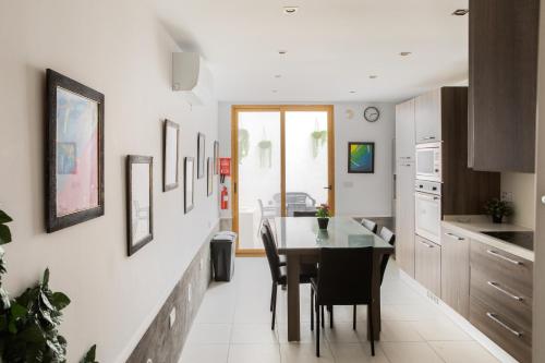 a kitchen and dining room with a table and chairs at Entire Luxury Sliema Townhouse Steps from Beach in Sliema