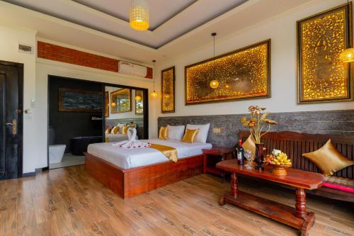 a bedroom with a bed and a table at Angkor Rithy Residence team in Siem Reap