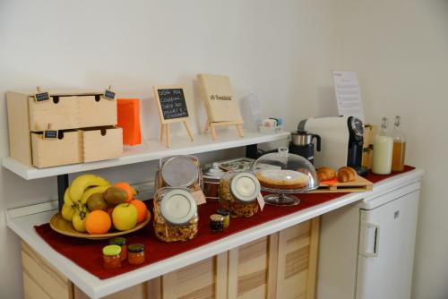 a kitchen counter with fruits and other items on it at Bed & Breakfast Ai Fontana in Villar Pellice