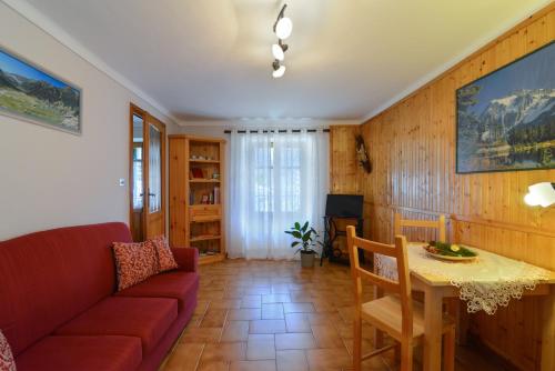 a living room with a couch and a table at Bed & Breakfast Ai Fontana in Villar Pellice