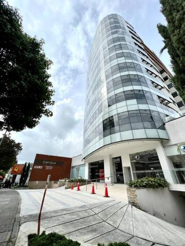 a tall building with orange cones in front of it at Cama Queen, Vista a las Montañas in Manizales