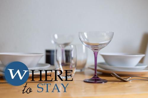 a table with a wine glass on a table at Leith Walk 1 bedroom Apartment in Edinburgh