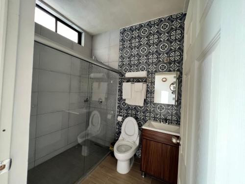 a bathroom with a toilet and a sink and a shower at Hotel Reforma in Tuxpan