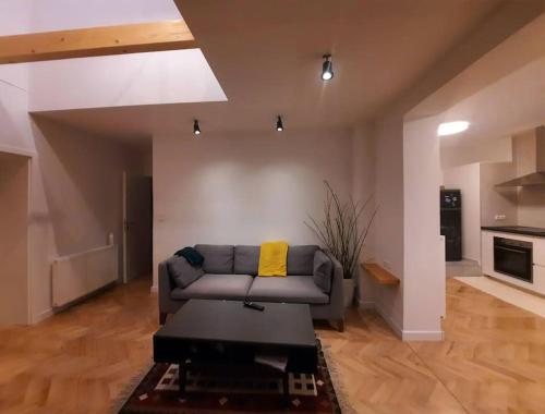 a living room with a couch and a table at Buda-city house in Trnávka
