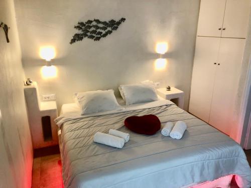 a bedroom with a bed with towels on it at The Muses of Santorini Private Jacuzzi Suites in Vóthon