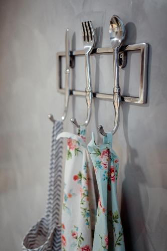 a rack with two utensils and a fork and spoon at Apartmany pod Pustevnami in Prostřední Bečva