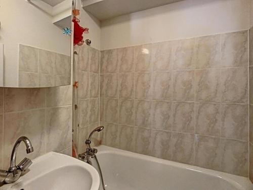 a bathroom with a sink and a bath tub at Appartement Le Biot, 3 pièces, 4 personnes - FR-1-573-115 in Le Biot