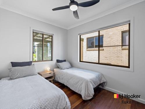 a bedroom with two beds and a ceiling fan at Bonnie Doon in Iluka