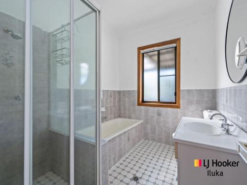 a bathroom with a shower and a sink and a tub at Bonnie Doon in Iluka