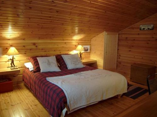 a bedroom with a bed in a log cabin at Chalet bois 9 pers, Grand confort, près pistes et commerces, Wi-Fi, Equipé, Parking, Non fumeur - FR-1-733-18 in Crest-Voland