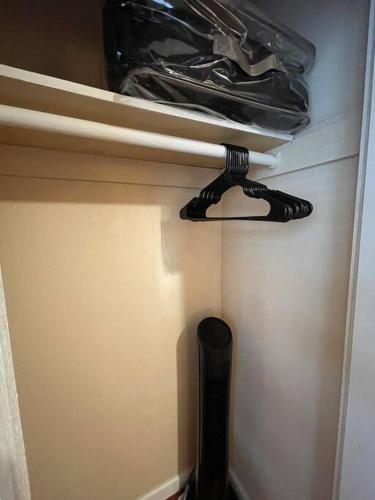 a black object is hanging from the door of a closet at Lovely Home 30MIN to Berkeley, SF, Napa in Pinole
