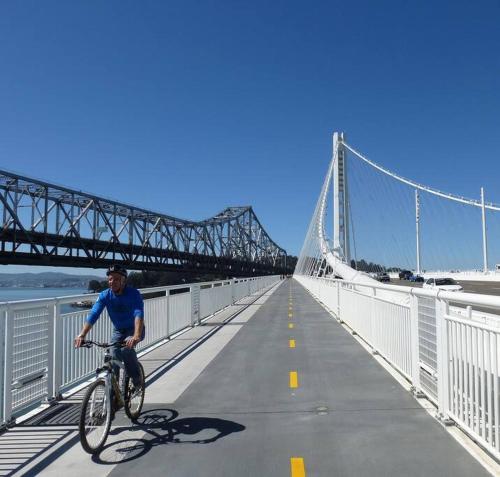 a man riding a bike on a bridge at Lovely Home 30MIN to Berkeley, SF, Napa in Pinole