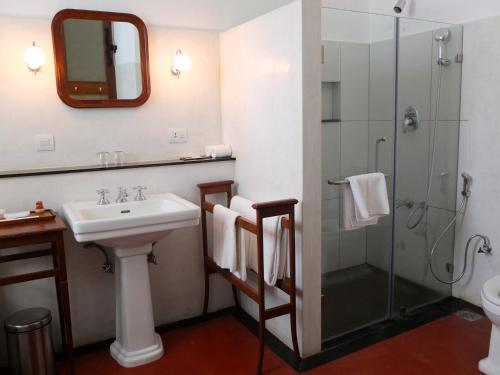 a bathroom with a sink and a shower at Palais De Mahe - A CGH Earth Experience in Puducherry