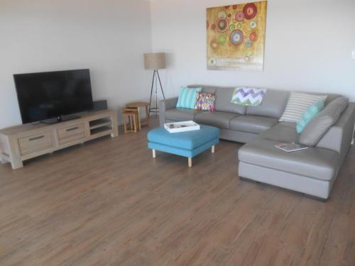 a living room with a couch and a flat screen tv at Sea La Vu in Stansbury
