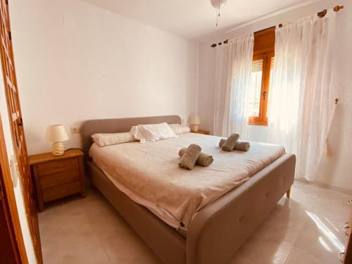 a bedroom with a bed with two teddy bears on it at Casa Maya in Benissa