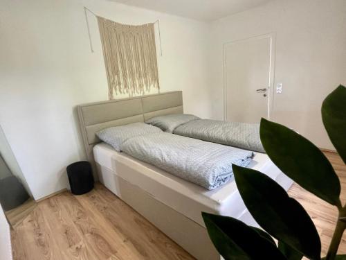 a bedroom with a bed and a potted plant at Lendorfer Cottage in Feldkirchen in Kärnten
