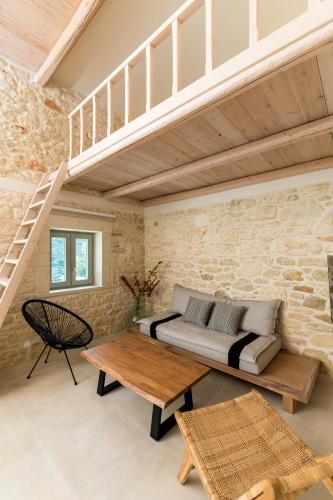 a living room with a couch and a table at Amvikas suites-Sitia, by Comfortbnb in Sitia
