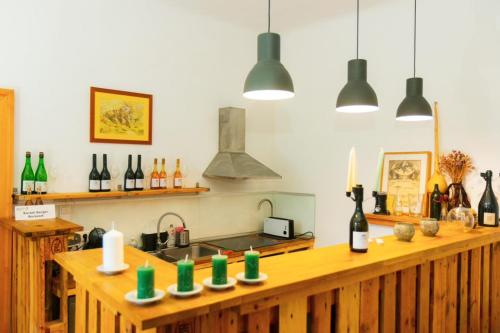 a kitchen with a counter with bottles of wine at Karádi-Berger Vendégház in Erdőbénye
