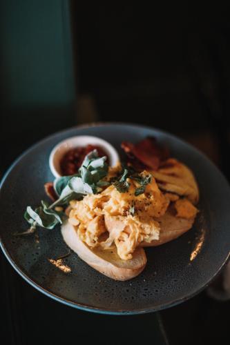 a plate of food with a sandwich and sauce at Prairie Hotel in Flinders Ranges