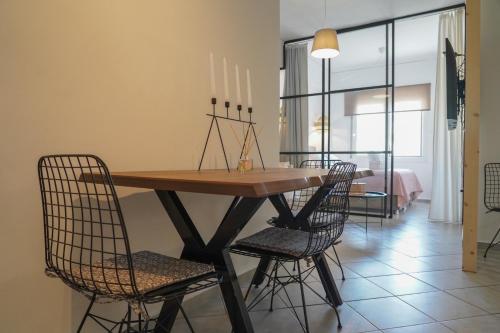 a dining room with a wooden table and chairs at Jelinas bright apartment in the centre of Nafplio in Nafplio