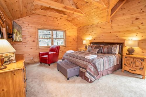 une chambre avec un lit et une chaise dans une cabine dans l'établissement Sugar Bear, à Sugar Mountain