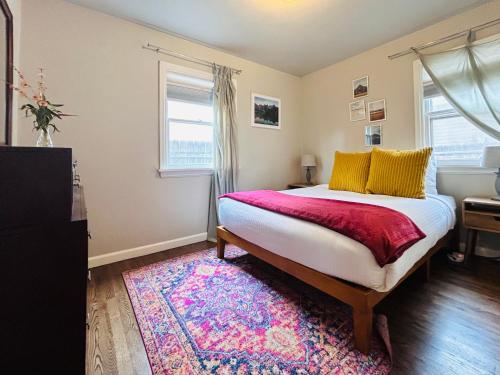 a bedroom with a bed and a rug and a window at Celebration Chalet! Quant, cozy, a few blocks from BSU and close to downtown Boise, Fireplace, 4 beds, and seating for 6 Pets Welcome! in Boise