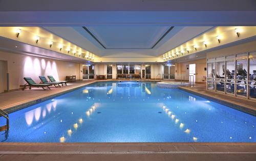 a large swimming pool in a hotel room at Orida Maidstone in Maidstone