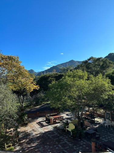 a park with a picnic table and trees and mountains at 南庄蔓森活Nan Juang Man Son Living in Nanzhuang