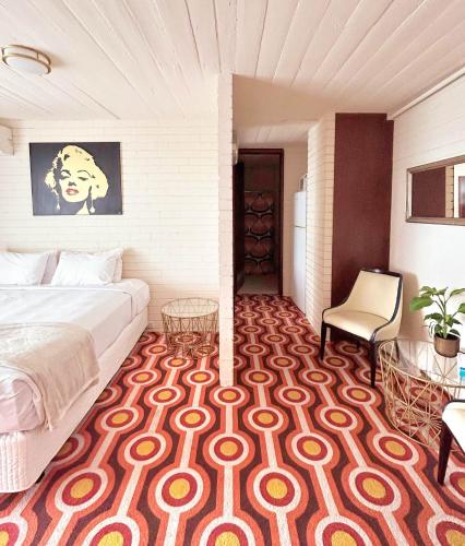 a bedroom with a bed and a table and a chair at Indian Ocean Hotel in Perth