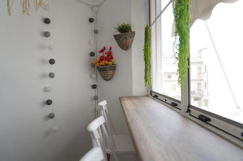 a room with a table and a window with plants at Jelinas bright apartment in the centre of Nafplio in Nafplio