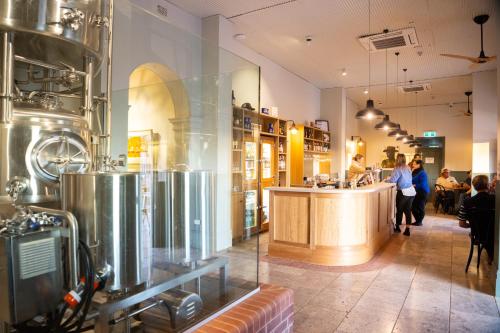 a restaurant with people walking around a counter in a store at Prairie Hotel in Flinders Ranges