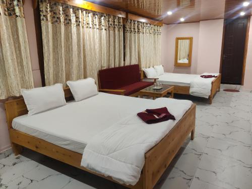 a room with two beds and a chair in it at Rio De Vallis Eco Resort in Kalimpong