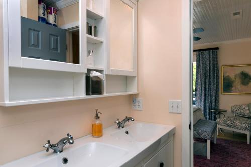 a bathroom with a white sink and a mirror at 2465 Racquet Club Villa in Seabrook Island