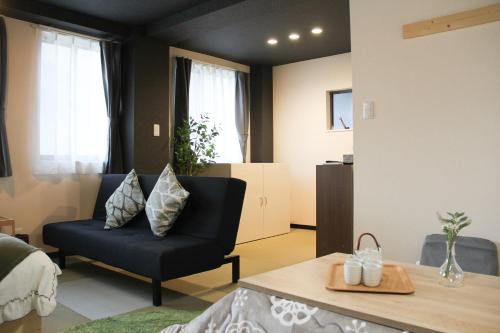 a living room with a black chair and a table at Tokyo Asakusa New Condo Sensoji-6min in Tokyo