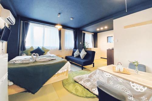 a bedroom with a bed and a chair in a room at Tokyo Asakusa New Condo Sensoji-6min in Tokyo