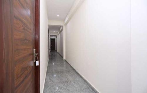 an empty hallway with a door and a hallway at POP 81169H Sunview Stay in Gurgaon