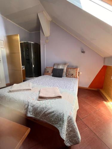 a bedroom with a large bed with two towels on it at White Garden in Oświęcim