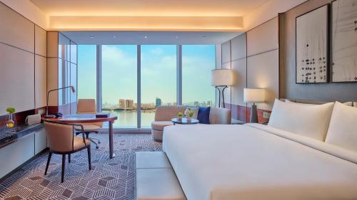 a hotel room with a large bed and a desk at InterContinental Guangzhou Exhibition Center, an IHG Hotel - Free Canton Fair Shuttle Bus and Registration Counter in Guangzhou