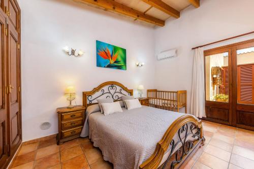 a bedroom with a bed and a window at Finca Kelly in Artá