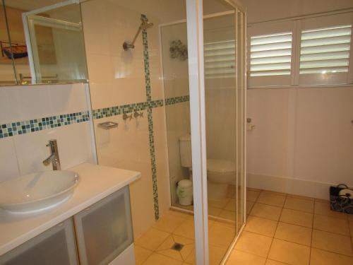 a bathroom with a glass shower and a sink at St Helens Beachfront - Absolute Beachfront in Edithburgh