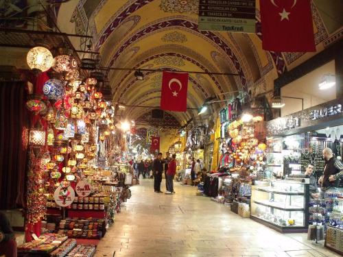 a market with people walking through a market with shops at Hotel Erden Sarayevo in Istanbul