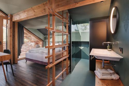 a bathroom with a bunk bed and a sink at Max Green Forest Apartments in Siusi