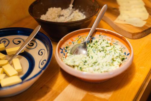 a bowl of food with a spoon in it on a table at Organic Tourist Farm Pri Plajerju in Trenta