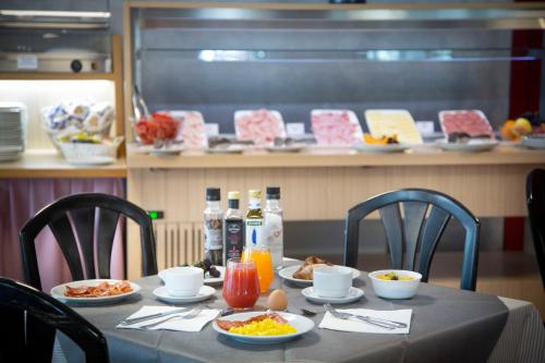 a table with plates of food and drinks on it at SunLake Hotel in Riva del Garda