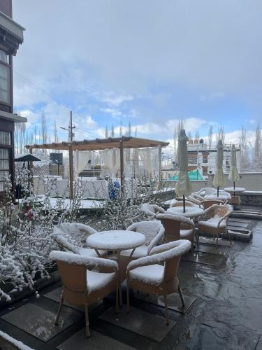 a group of tables and chairs covered in snow at Ashoka Ladakh in Leh