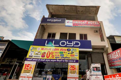 um edifício com placas em frente a uma loja em OYO Flagship 80902 Swagat Hotel em Bhiwadi