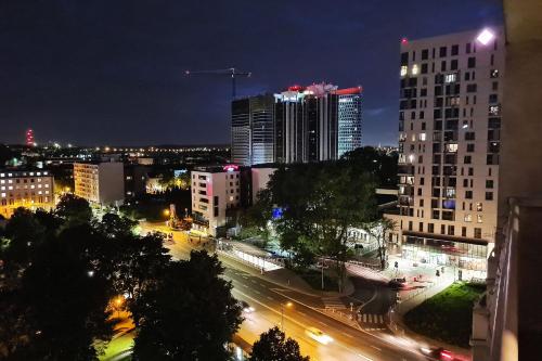 a city skyline at night with buildings and traffic at Kairos Apartments - Gwarek - darmowy parking, ścisłe centrum in Katowice