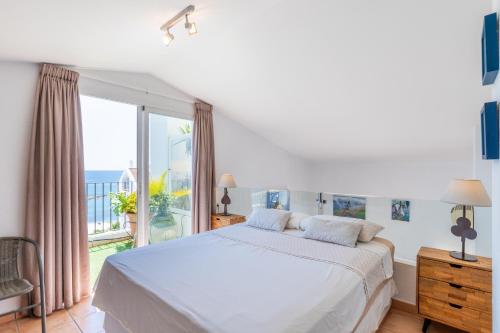 a bedroom with a bed and a large window at Penthouse center Altea in Altea
