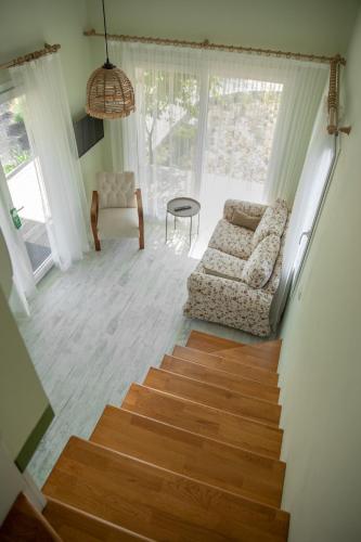 a living room with a staircase and a couch and a table at Gadura Kır Evleri Urla in Urla